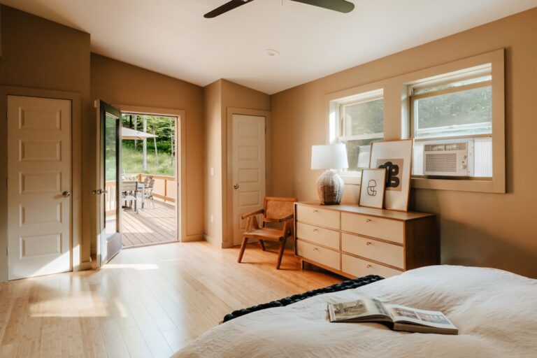 A bedroom with a large bed and a ceiling fan — Photo by Clay Banks on Unsplash