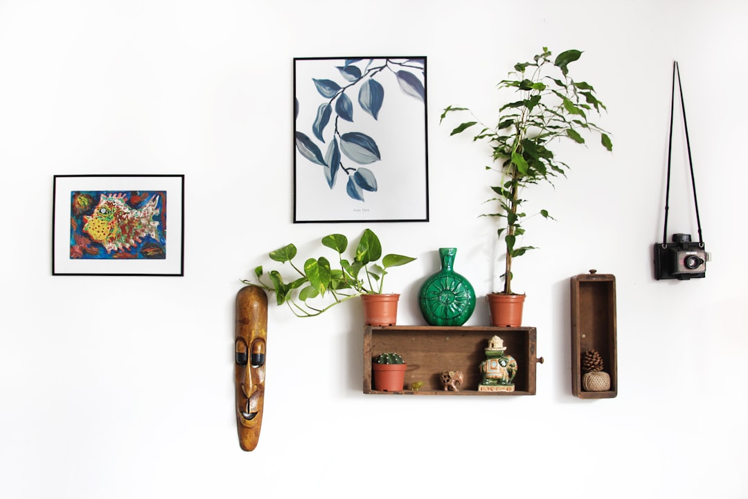 Renter-Friendly Wall and Floor Decorating Ideas You'll Actually Love 1 Assorted wall decor pieces arranged on a white apartment wall - renter-friendly gallery wall ideas