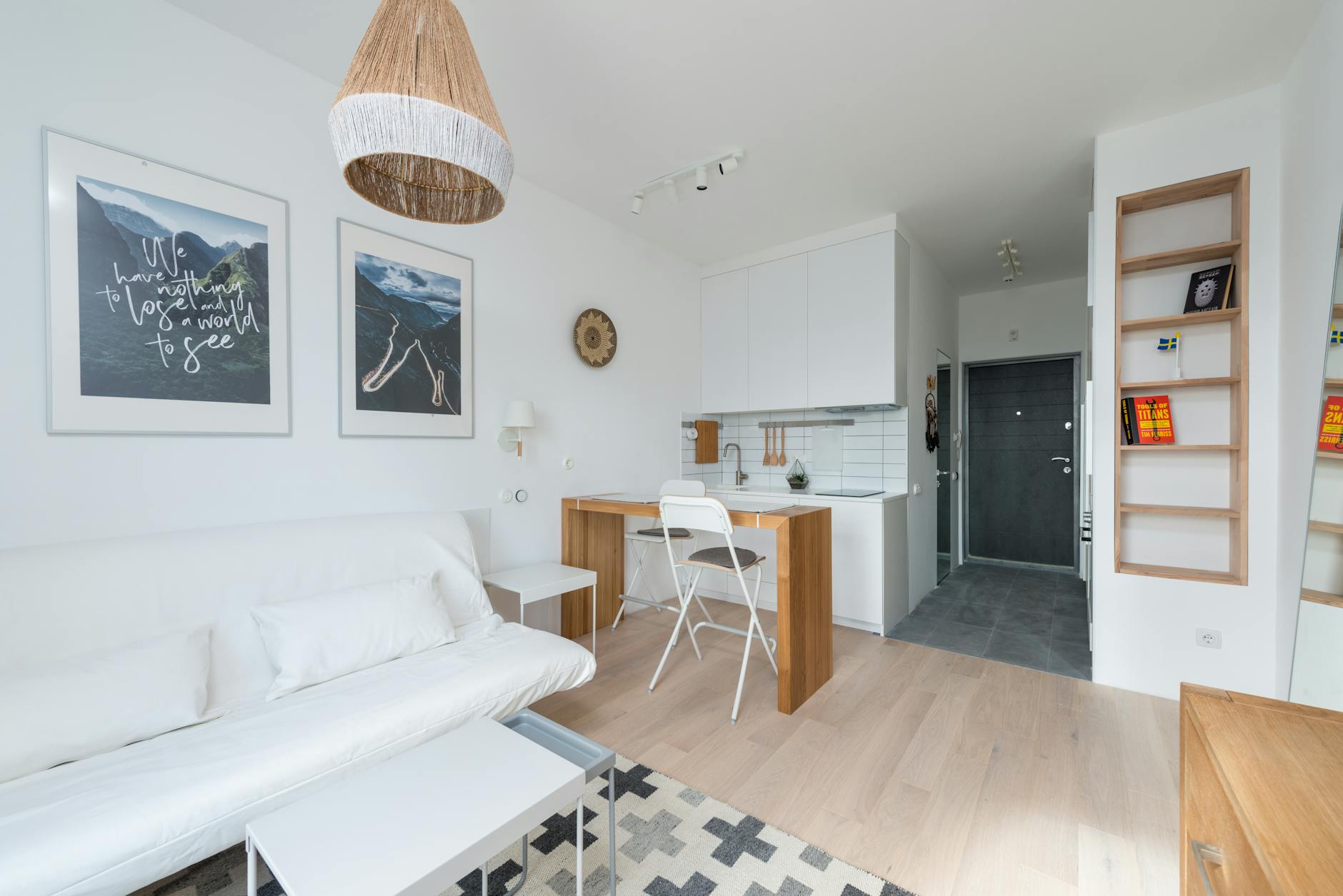 How to Decorate a Small Apartment on a Budget (Without It Looking Cheap) 1 Minimalist studio apartment with wooden floors and white sofa - small apartment decorating on a budget